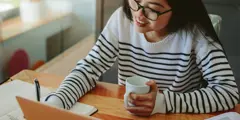 Asian Girl Sitting At Desk Gettyimages 1132443057